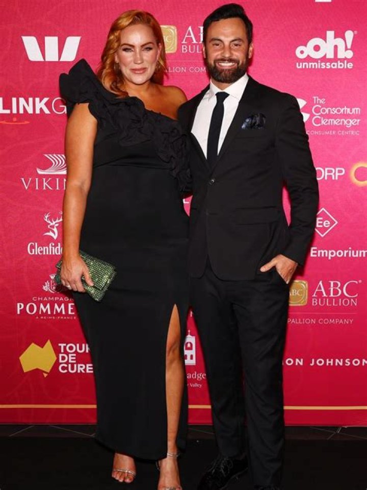 Jules Robinson and husband Cameron Merchant kissing